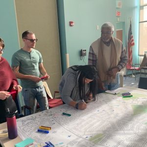Members of the West Sugar Creek/I-85 Community Innovation Incubator team meet in the community.